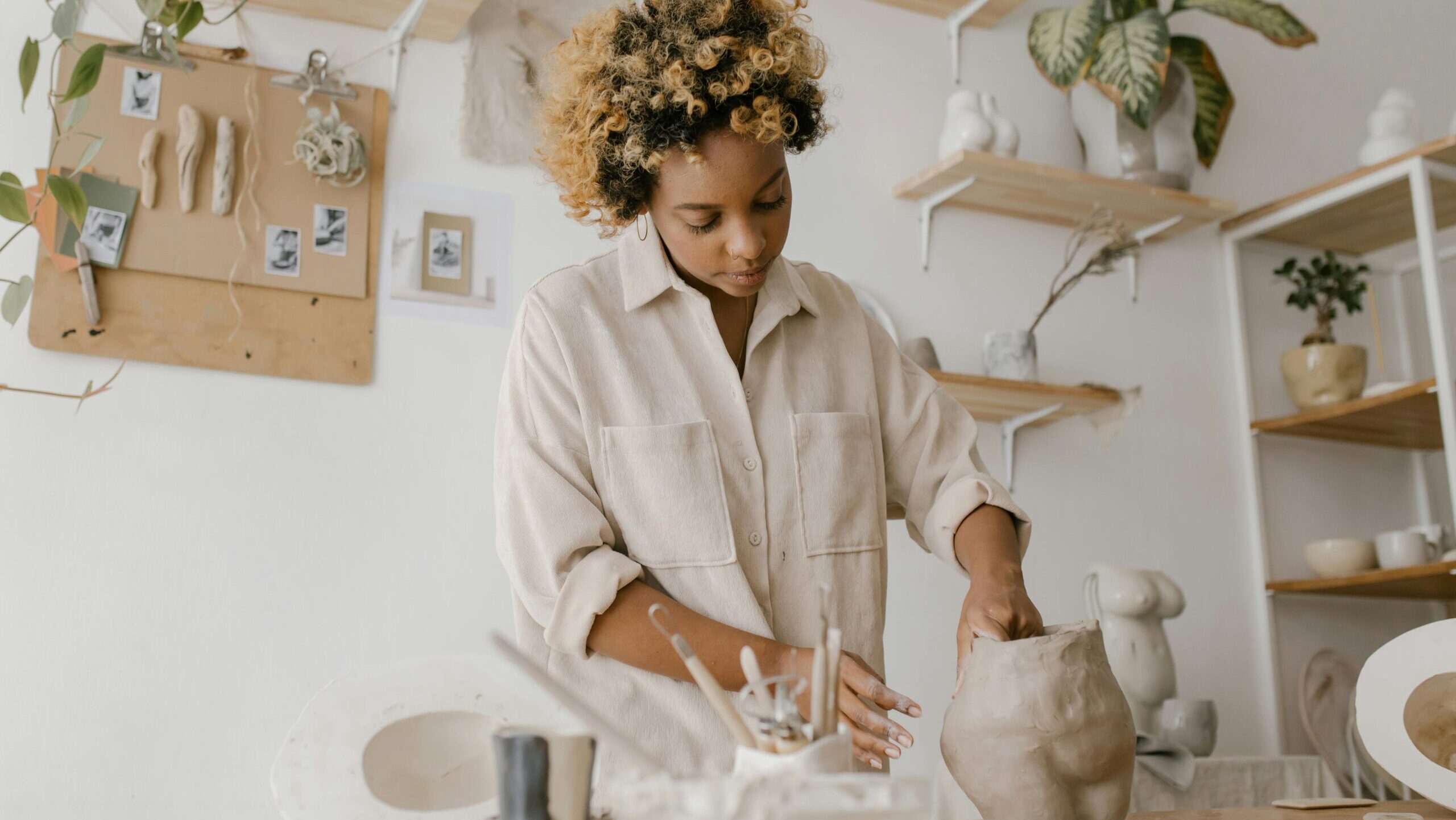 woman sculpting a pottery piece