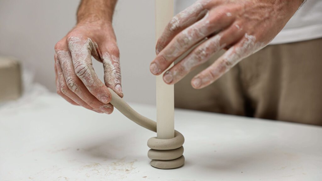 person coiling a candlestick