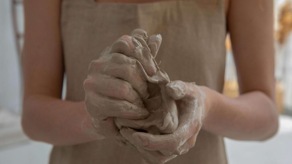 person holding ceramic clay