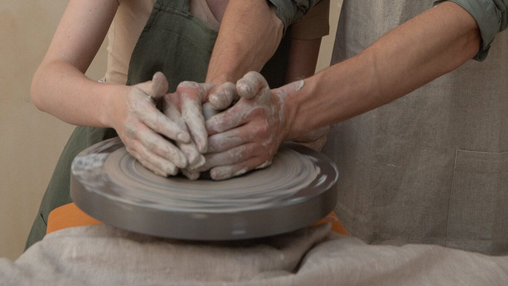 two people using pottery wheel